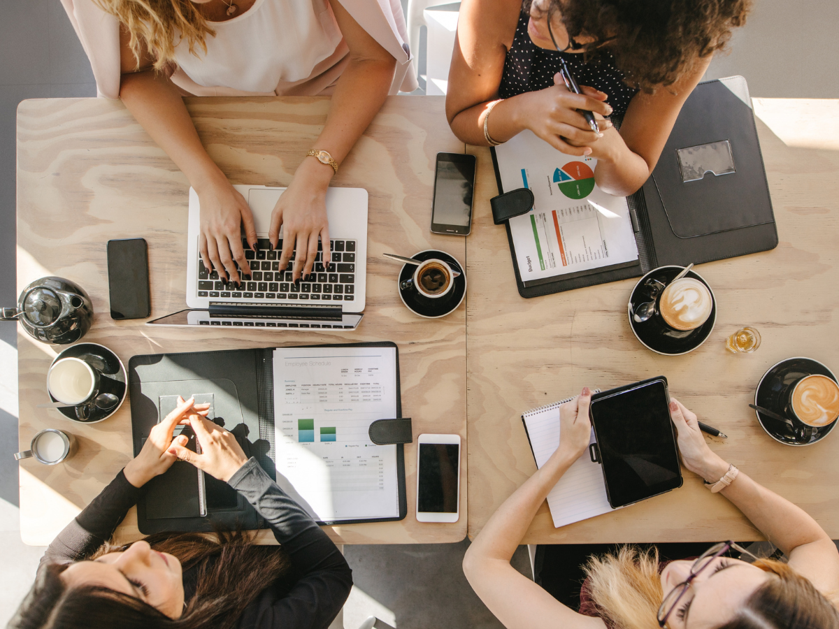 over head shot of women working at a table together