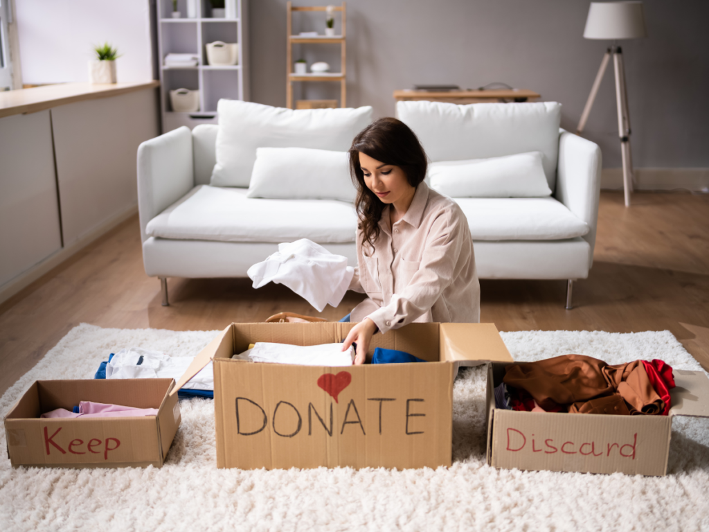 Three labeled boxes for keeping, donating, and tossing items