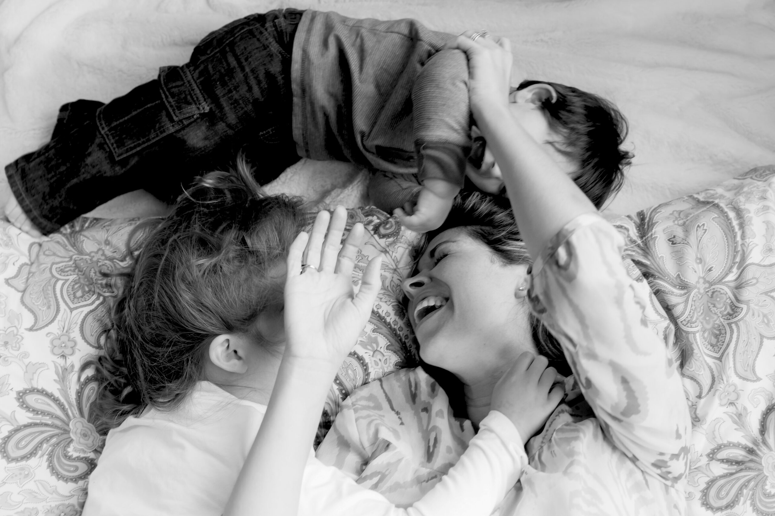 women laying on the floor with children